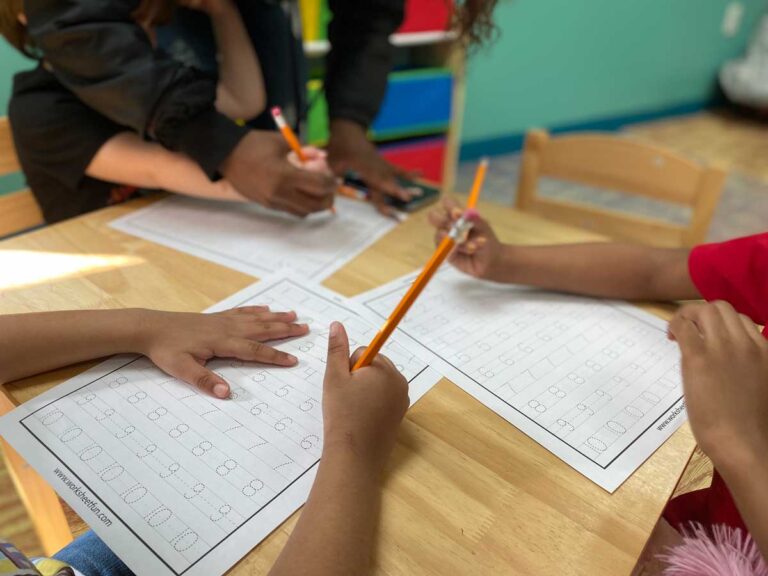 Preschoolers Practicing Tracing Their Names at Best Daycare in Louisville